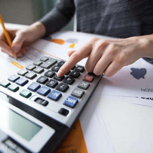 close-up-female-hand-counting-with-calculator close-up-female-hand-counting-with-calculator